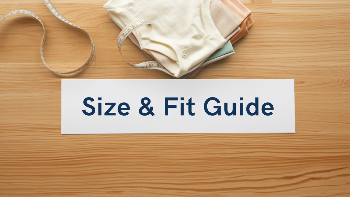 Size and fit guide banner with a measuring tape and folded organic cotton baby onesies on a wooden surface