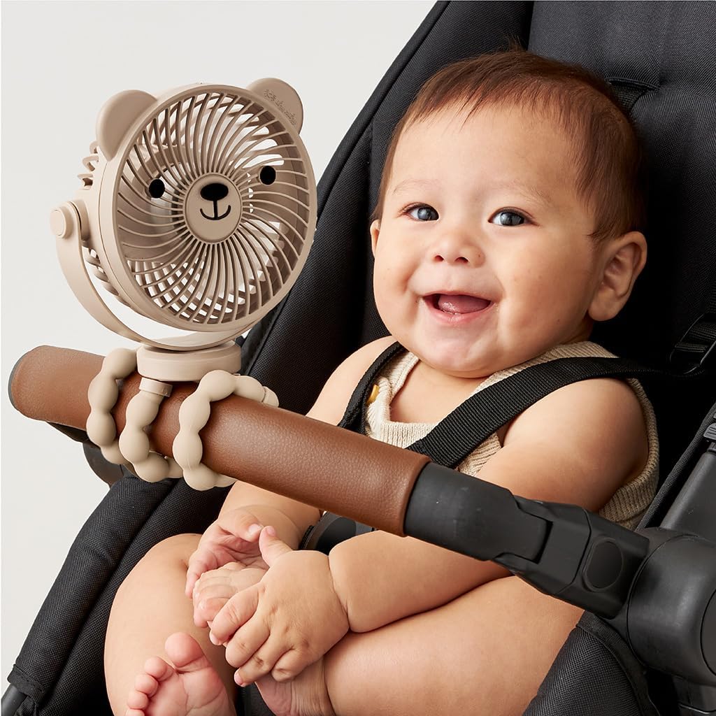 Happy baby with a toy in a car seat