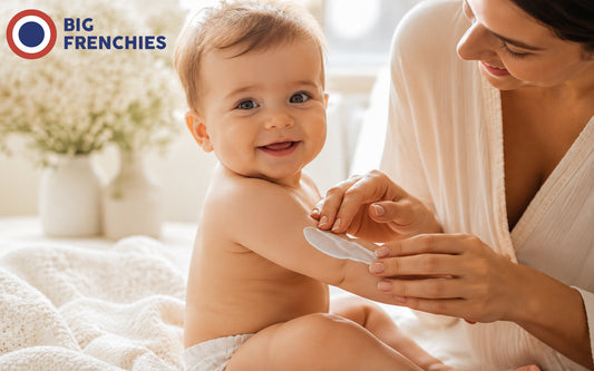 Mom putting cream on baby's arm 