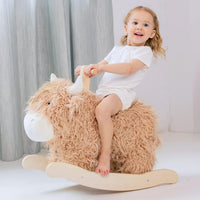 Jolie Vallee baby rocking horse shaped like a plush yak on a solid wood rocker with handles
