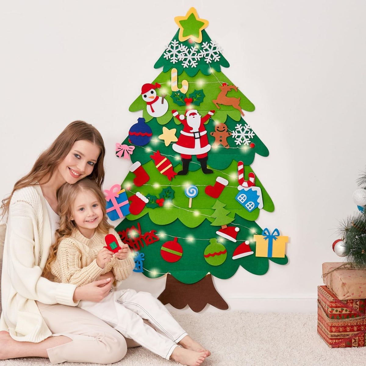 Onekka felt Christmas tree for kids on a wall with felt ornaments and string light