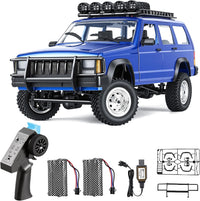 Goolsky silver 1:12 scale RC rock crawler with LED lights on rocky ground