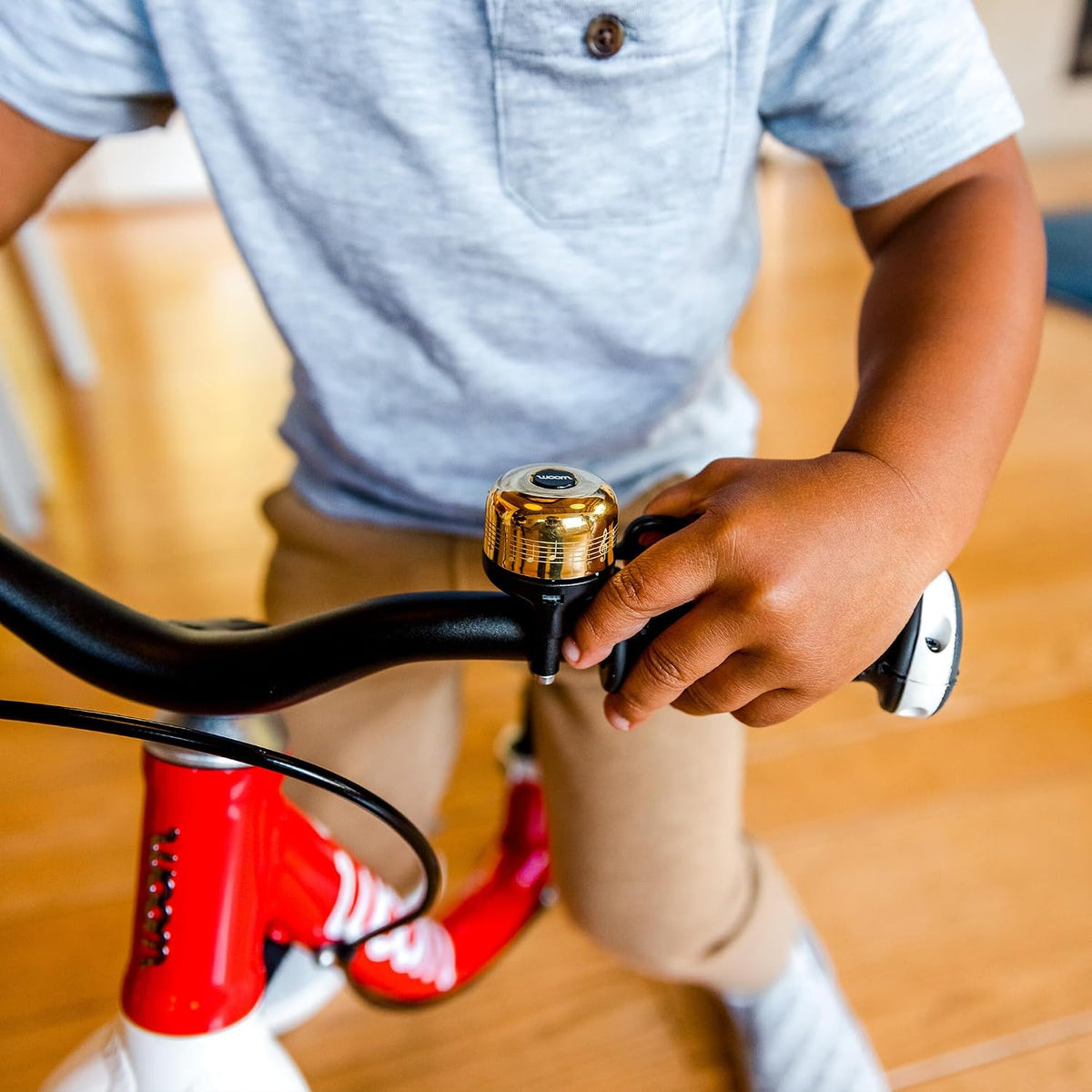 woom VIENNA kids bike bell in brass mounted on a children's bike handlebar - view 7
