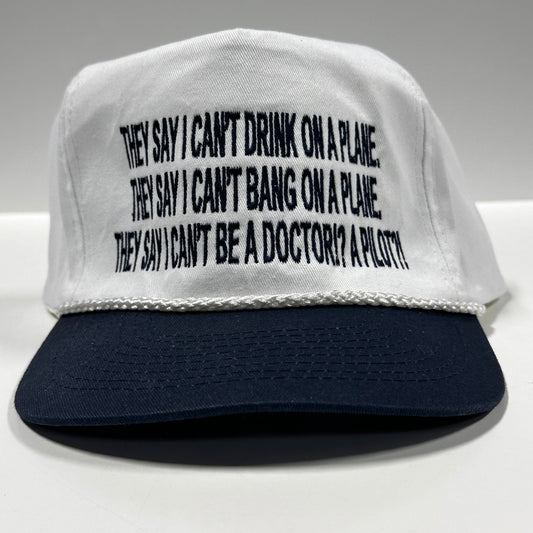 They say I can’t drink on a plane they say I can’t bang on a plane on a white crown navy brim SnapBack hat cap custom embroidered