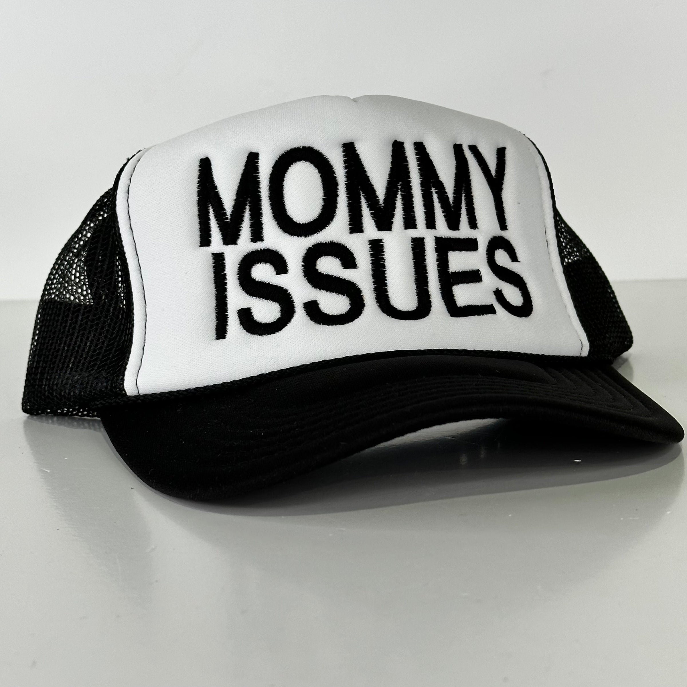 Mommy Issues on a black and white mesh trucker SnapBack cap hat custom embroidered